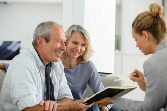 smiling businesswoman in office meeting with laptop two females shaking hands
